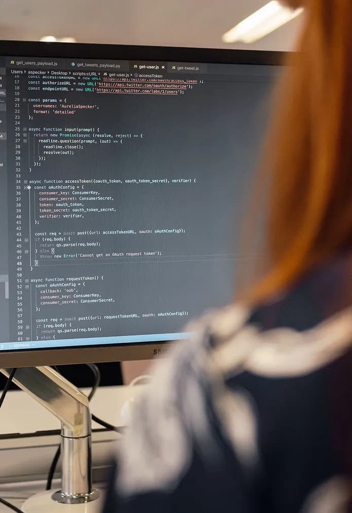Developer reviewing code on a large monitor